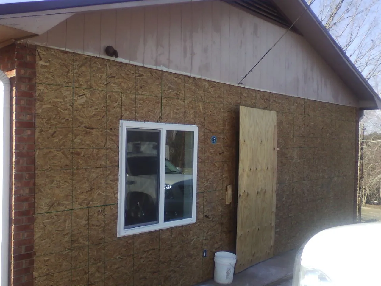 OSB sheathing on a garage addition wall before siding in Ola