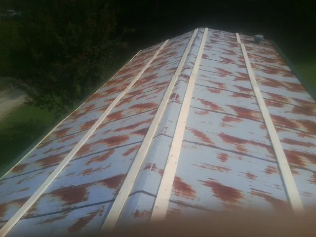 Rusted metal roof panels with new wood purlins before replacement — Storm Damage Roof Repair in Ola by Roofing Brothers